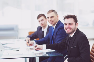 smiling business team sitting at Desk in office