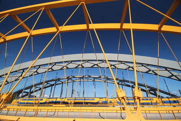 Bright yellow bridge named Hogeweidebrug over the Amsterdam-Rhine canal in Utrecht for traffic in...