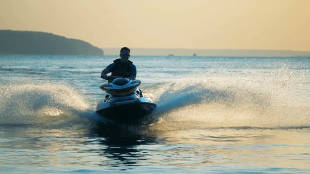 Man jet skiing on water, close up.