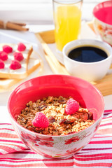 still life: granola with raspberries, toast with curd cheese and raspberries, coffee and orange juice