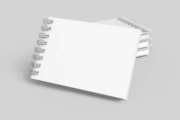 Pile of white hard cover notebooks