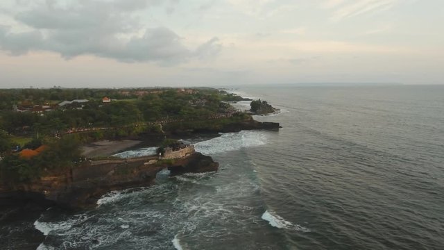 Aerial view of Traditional Hindu temple Tanah Lot Bali, Uluwatu, Indonesia. Balinese Hindu Temple, old hindu architecture, Bali Architecture, Ancient design. 4K video. Travel concept. Aerial footage.