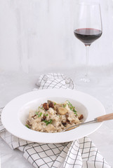 Mushroom risotto Traditional italian porcino rice Dish White background Checkered napkin Copy space