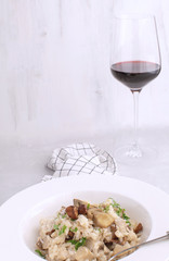 Mushroom risotto Traditional italian porcino rice Dish White background Checkered napkin Copy space