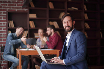 close up.smiling Manager works on laptop. business concept