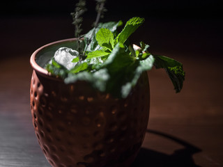 Cocktail in a beautiful glass on the table. In a dark bar