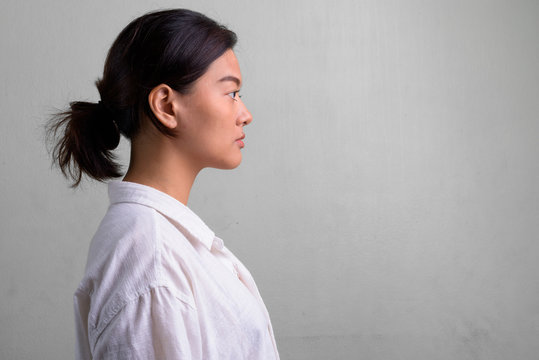 Profile View Of Young Beautiful Asian Woman With Hair Tied
