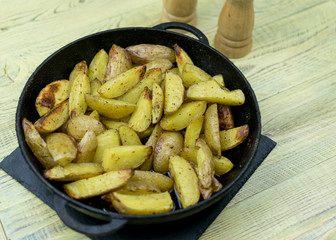 Fried potatoes in a frying pan.