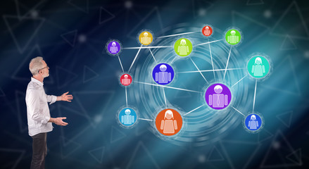 A social network concept explained by a businessman on a wall screen