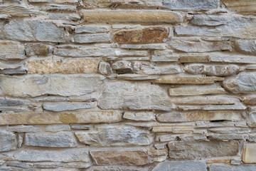 High detailed background old slim stone brick wall.