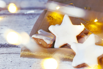 delicious cinnamon stars at golden fabric with light string