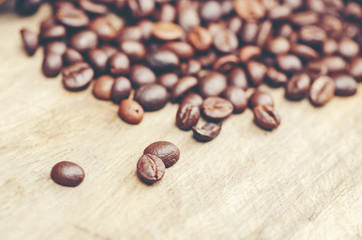 coffee beans on wooden background, arabica coffee, vintage filter image