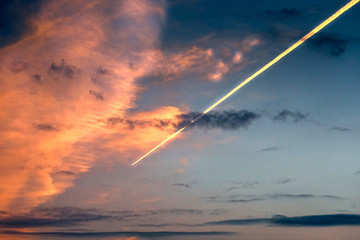 Fototapeta na wymiar Meteorite or airplane inversion trail in the sky