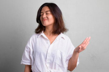 Portrait of young beautiful Asian woman with short hair