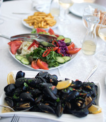 Cooked mussels served on the table with salad. Albania. Adriatic coast. National food