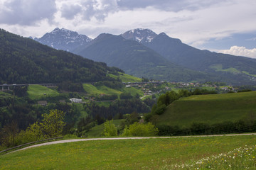 View over Brenner in spring time with  a meadow with flowers in forefront