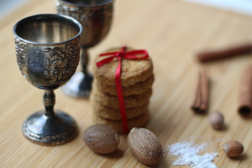 Two glasses, biscuits with red ribbon. Template of making cookies. Baking Christmas Cookies with red ribbon. Holiday christmas background for baking cookies