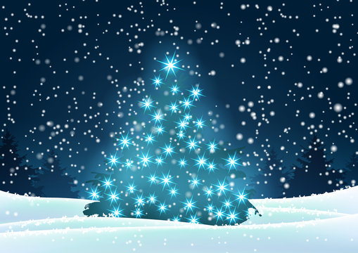 Christmas tree with blue lights in dark landscape