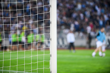 Players behind the goal net. Soccer concept