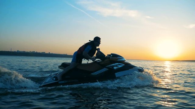 One person sliding on jet ski, side view.
