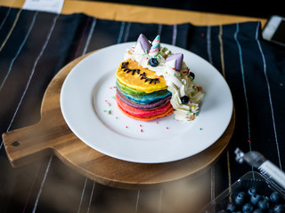 Fresh baked cute unicorn Rainbow Pancake with. kids meal.