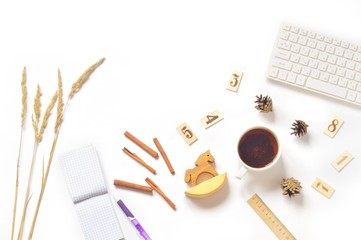 Women's work space/ Flat lay many autumn items, computer and tea cup on a white office table. Top view photography