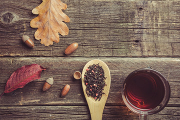 Autumn composition. Cup of tea, autumn leaves and acorns autumn tea party.