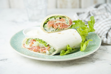 Salmon wraps with lettuce, cucumber and lemon