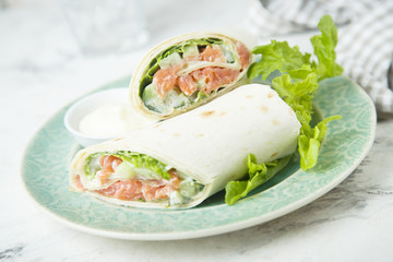 Salmon wraps with lettuce, cucumber and lemon