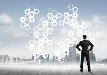 Pensive businessman looking at user interface against modern city background