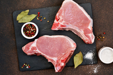 Pork with ribs. Tenderloin. Entrecote. Fresh and raw meat. Organic food.Meat with spices: pepper,...