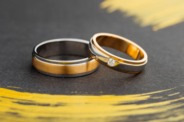  Two tone silver and gold wedding rings on black background