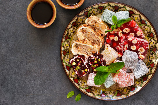 Turkish Delight. Traditional Turkish sweets. Loukum and coffee on a dark background.