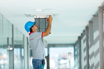 Worker installing air conditioner