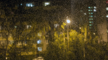 Raindrops on the window glass. The view from the window