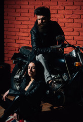 Fototapeta na wymiar couple in garage. biker couple in garage. couple in garage with motorcycle. sexy couple repair bike. on the way to garage.