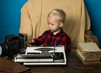 Fototapeta na wymiar Little journalist work with vintage typewriter and camera at desk. Because I am a journalist