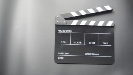 Fototapeta na wymiar Clapper board or movie slate use in video production or movie and cinema industry. It's black color on black background.