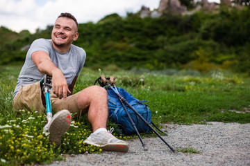 Overjoyed young man with disability resting on the grass
