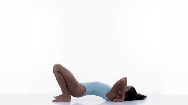 amazing female yoga instructor moving between poses against white background