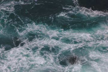 Fototapeta na wymiar top view shot of wavy blue ocean for background