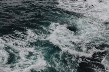 Fototapeta na wymiar high angle view shot of wavy blue ocean for background