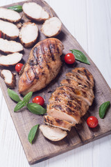 Grilled chicken breast ( fillet ) with basil and tomatoes