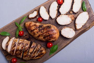 Grilled chicken breast ( fillet ) with basil and tomatoes