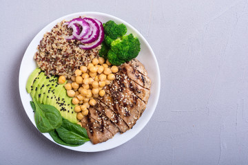 Buddha bowl with broccoli , quinoa , grilled chicken , avocado and spinach