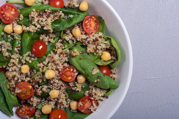 Spinach salad with quinoa , tomatoes and chickpea