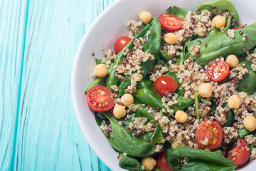 Spinach salad with quinoa , tomatoes and chickpea