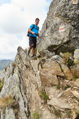 Hiker with backpack in the mountains
