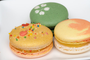 Homemade assorted macarons beautifully decorated with colorful hearts, green tea and yellow and gold color