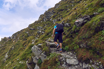 Hiker with backpack in the mountains